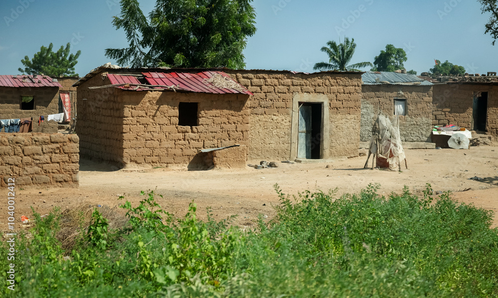 Rural village life in Angola featuring traditional mud huts and vibrant ...