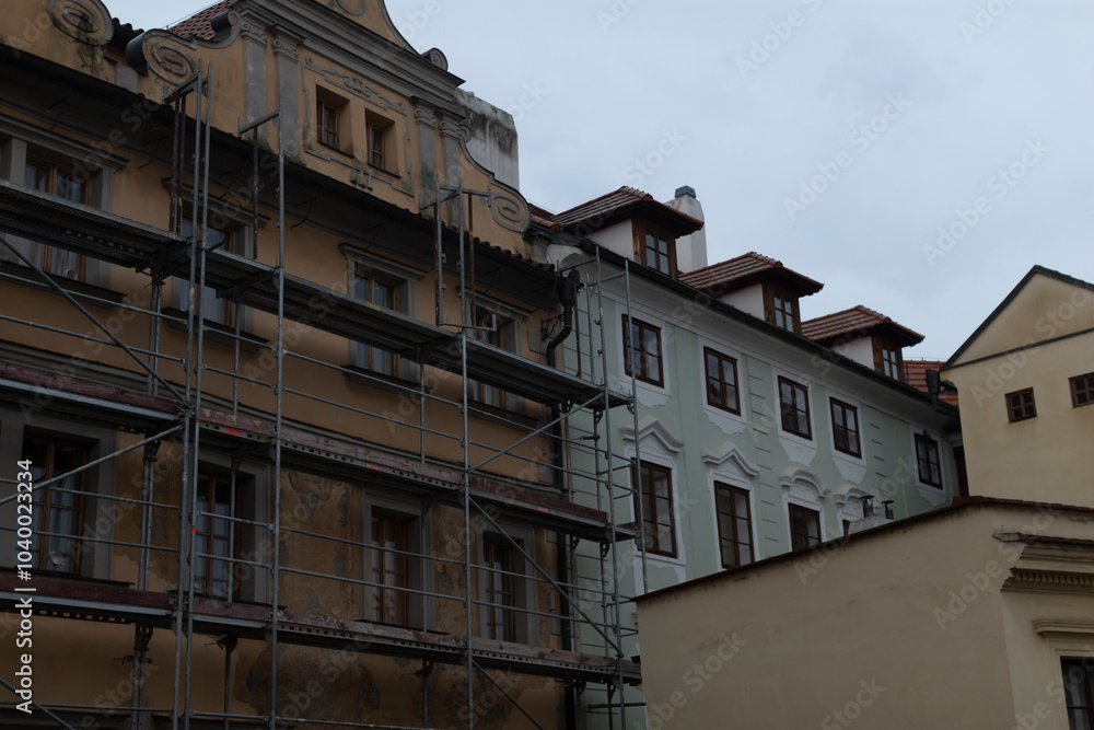 Fototapeta premium Scaffolding contrasts with historical urban architecture, emphasizing significant renovation efforts