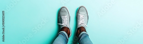 Casual noname sneakers on african american person against light color background