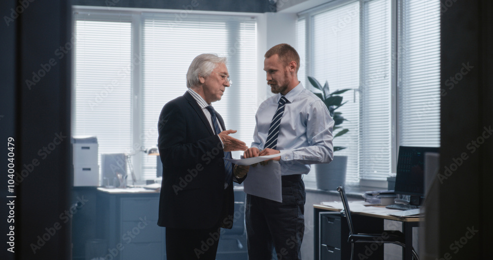 Two different businessmen discussing financial market data, studying papers and documents, talking about profitable trades with partners and business strategy. Work in international financial company. Two different businessmen discussing financial market data, studying papers and documents, talking about profitable trades with partners and business strategy. Work in international financial company.