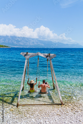 Enjoying a sunny day on Brac Island with swings by the crystal-clear Adriatic Sea