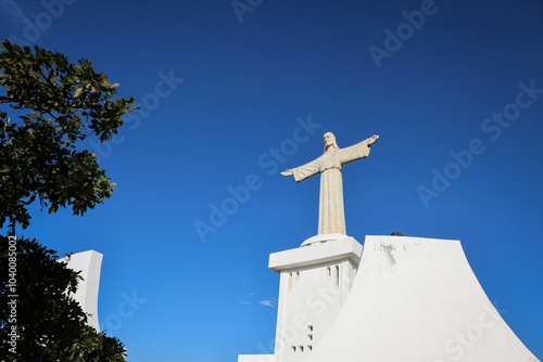 The impressive Christ the King monument in Lubango Angola against a bright blue sky on a sunny day photo