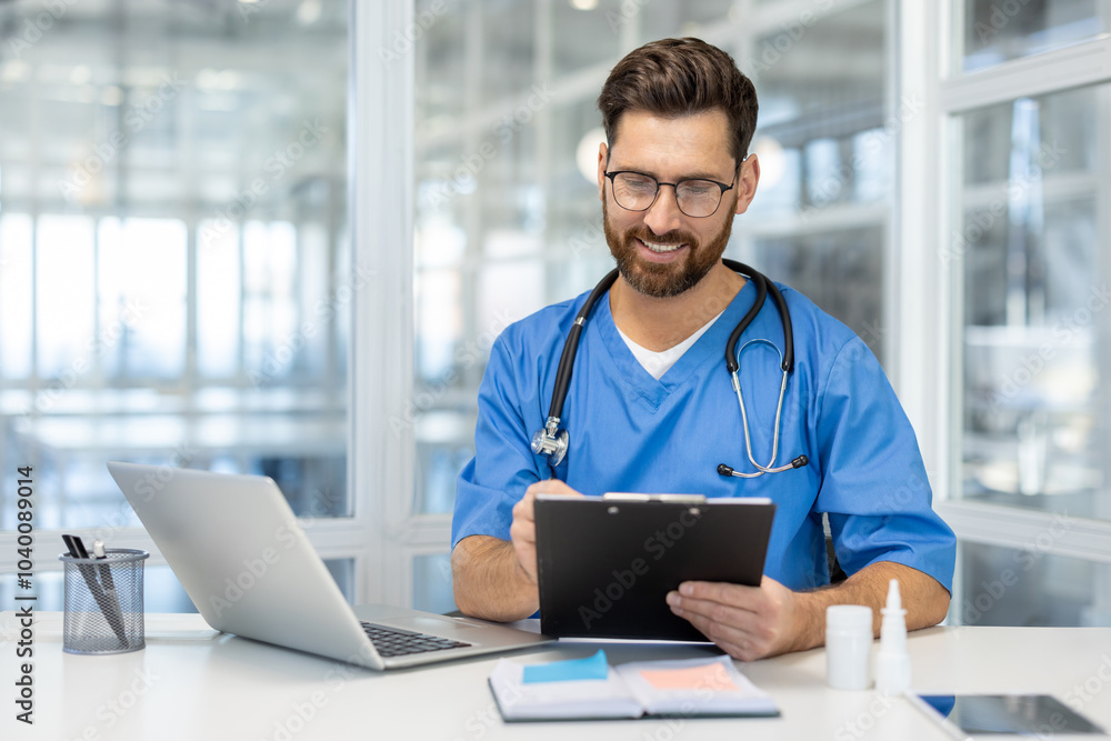 Doctor in blue scrubs smiles while writing on clipboard in modern office. He works confidently with laptop, showcasing professional healthcare environment and dedication to medical field. Doctor in blue scrubs smiles while writing on clipboard in modern office. He works confidently with laptop, showcasing professional healthcare environment and dedication to medical field.