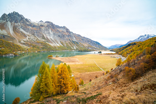 Upper Engadine, Lake Sils, and the village of Isola, photographed from above in autumn. photo