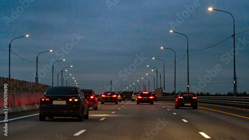 Valokuva A busy highway at night with many cars and lights