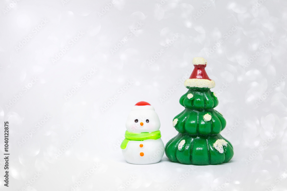 Cute little snow man with Christmas tree over blurred white bokeh background, Christmas card background idea Cute little snow man with Christmas tree over blurred white bokeh background, Christmas card background idea