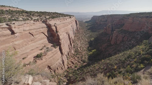 Colorado National Monument Park near the city of Grand Junction. Sheer-walled, Red rock canyons, Rim Rock Drive, Towering monoliths within a vast plateau and canyon panorama USA