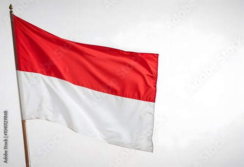 a beautiful red and white Indonesian flag waving on top a pole.