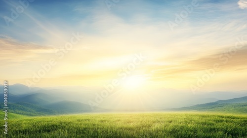 A serene landscape at dawn, featuring golden sunlight illuminating a grassy field and distant mountains under a blue sky.