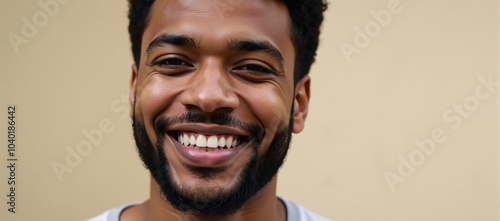 Cheerful young bearded Black man smiling outdoors radiantly expressing positivity