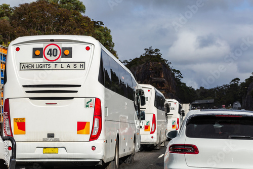 40 when lights flash sign on back of busses traveling in heavy traffic on highway photo