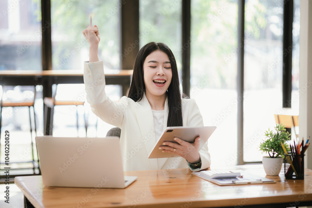Beautiful Asian businesswoman focused on reviewing documents in a modern office. Beautiful Asian businesswoman focused on reviewing documents in a modern office.