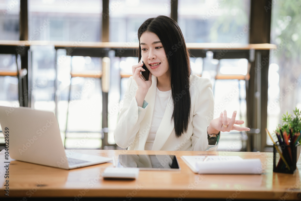 Asian accountant using laptop computer to analyze sales growth in global workplace market. Accounting concept. Asian accountant using laptop computer to analyze sales growth in global workplace market. Accounting concept.