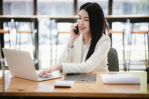 Asian accountant using laptop computer to analyze sales growth in global workplace market. Accounting concept.