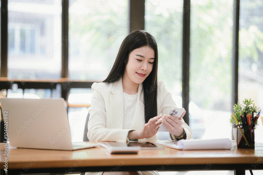 Asian accountant using laptop computer to analyze sales growth in global workplace market. Accounting concept. Asian accountant using laptop computer to analyze sales growth in global workplace market. Accounting concept.