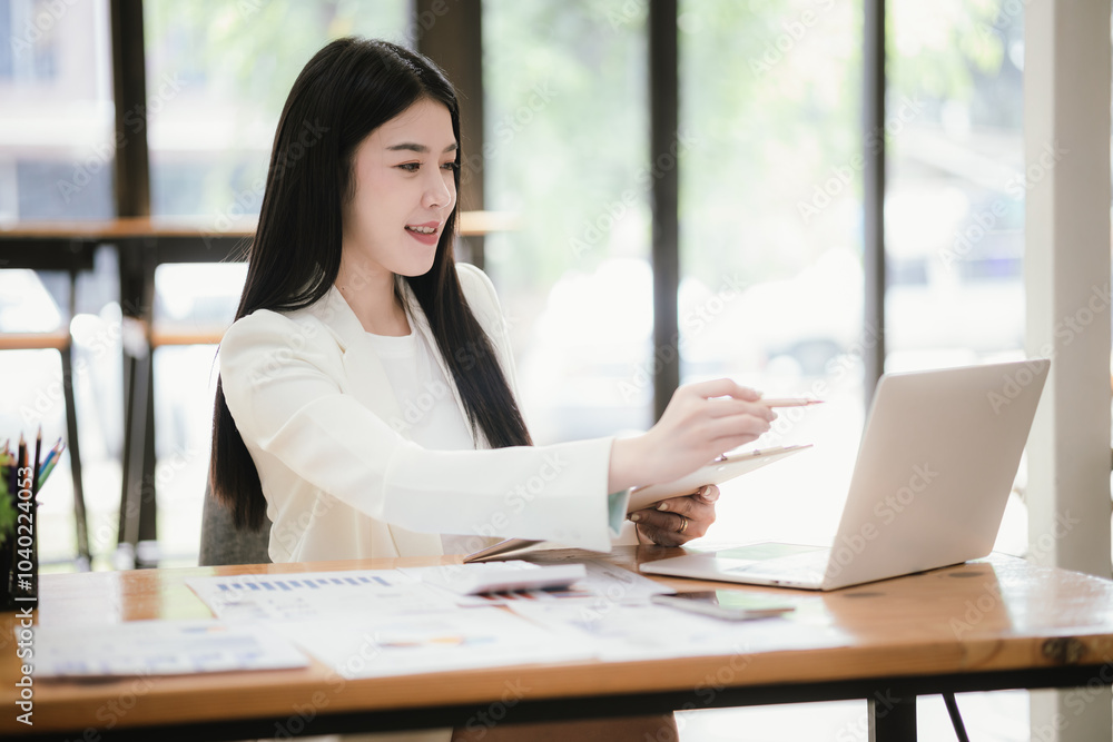 Asian businesswoman working with laptop in office Asian businesswoman working with laptop in office