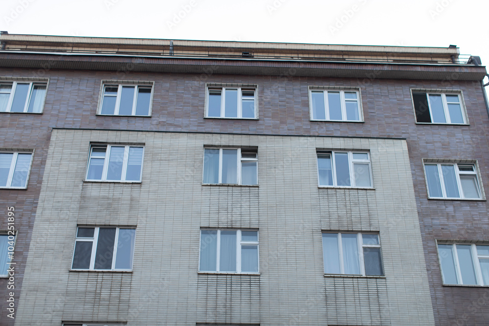 A detailed closeup view of an urban apartment building that showcases its unique and distinctive architectural style A detailed closeup view of an urban apartment building that showcases its unique and distinctive architectural style