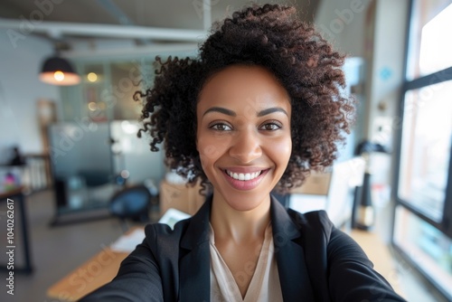 Woman taking a photo of herself at work