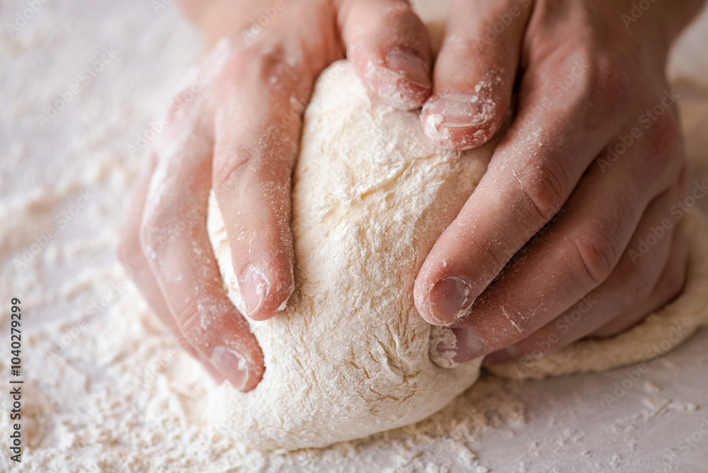 Close-up of baker making dough, person knead dough on table Close-up of baker making dough, person knead dough on table