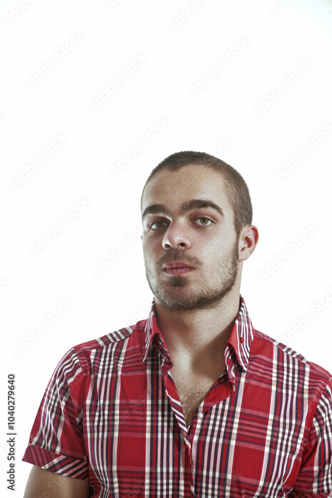 Obraz premium Young man with short hair and red shirt posing on white backgrou