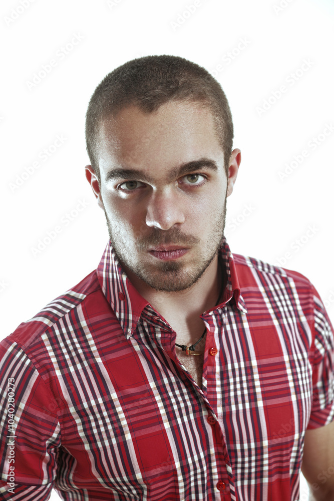 Fototapeta premium Serious young man wearing red shirt staring at camera
