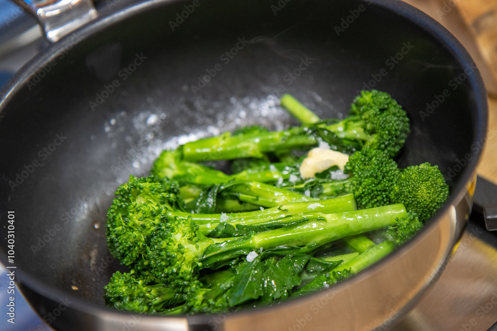 A pan or delicious broccoli cooking in a pan with a pinch of salt