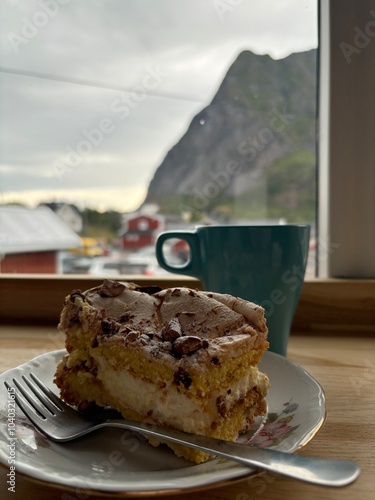 Fototapeta Naklejka Na Ścianę i Meble -  piece of cake with chocolate and coffie with a view of a mountain in Norway
