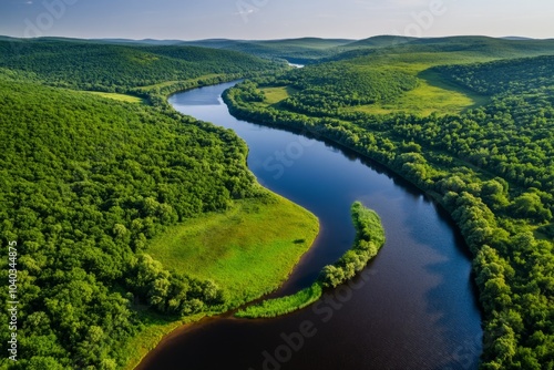 Cerulean river winding through a forest, with vibrant green trees lining the banks and the water reflecting the clear blue sky above