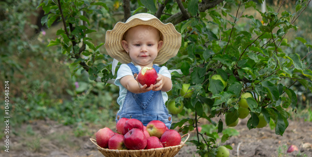 little girl eats an apple in the garden. Selective focus