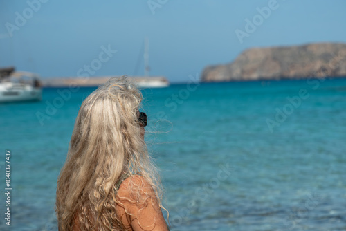 Woman admiting the clear waters of Gramvousa, Crete