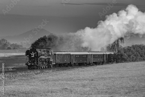 Czech steam locomotive driving through the countryside photo