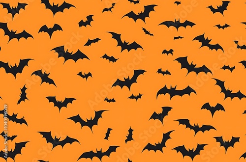 Orange background black bat silhouettes flying in the sky