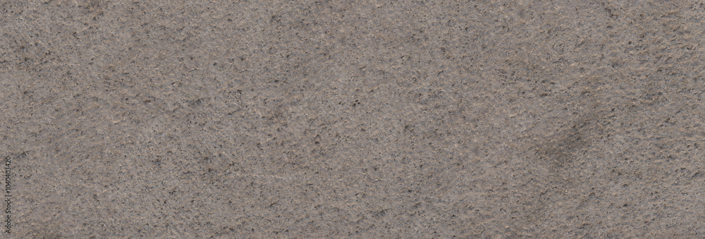 Panoramic background of natural stone texture with a granular surface and rough finish, in soft gray tones, ideal for exterior cladding Panoramic background of natural stone texture with a granular surface and rough finish, in soft gray tones, ideal for exterior cladding