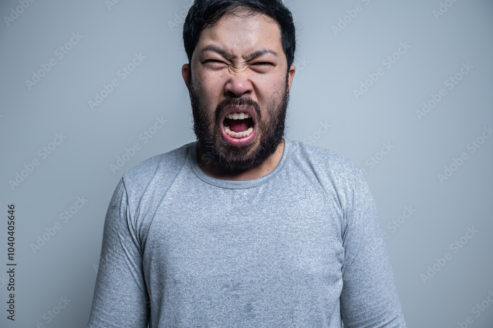 Asian handsome man angry on white background,Portrait of young Stress male concept,Bad mood after talking on the phone Asian handsome man angry on white background,Portrait of young Stress male concept,Bad mood after talking on the phone