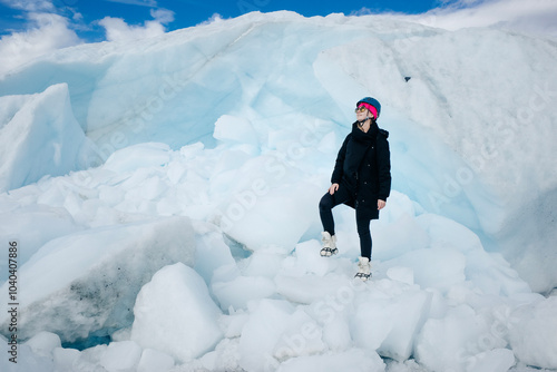 Woman is hiking on Matanuska Glacier near Glenn Highway in Alaska. photo