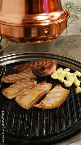 grilling samgyeopsal on chacoal grill