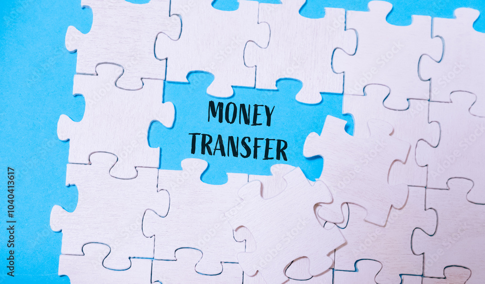 Puzzle pieces with Money transfer text on a blue background Puzzle pieces with Money transfer text on a blue background