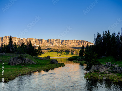 Small stream flows out of Brooks Lake at sunset in Wyoming photo