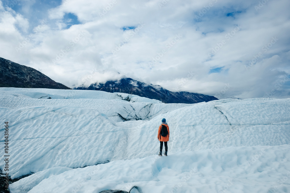 Woman is hiking on Matanuska Glacier near Glenn Highway in Alaska. Woman is hiking on Matanuska Glacier near Glenn Highway in Alaska.