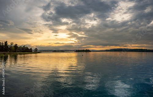 Sunset over the Lutzelau and Ufenau islands, Lower Zurich Lake (Untersee) between Rapperswil and Freienbach, Switzerland photo