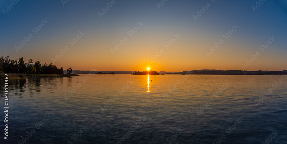 Sunset over the Lutzelau and Ufenau islands, Lower Zurich Lake (Untersee) between Rapperswil and Freienbach, Switzerland Sunset over the Lutzelau and Ufenau islands, Lower Zurich Lake (Untersee) between Rapperswil and Freienbach, Switzerland