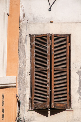 Old wooden weathered vintage window with shutters in Rome, Italy photo