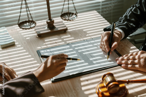 Lawyers are reviewing and signing important documents for a client in their law office