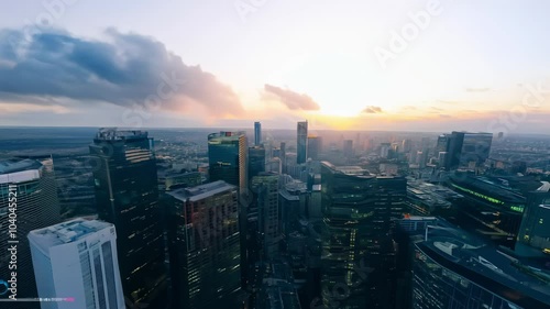 Wallpaper Mural FPV fly-through over a cityscape with buildings changing color as the day transitions from dawn to dusk. Torontodigital.ca