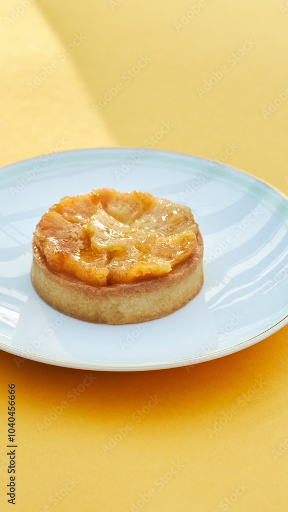 Yellow Pastry with Fruit Filling on Plate and Yellow Background Yellow Pastry with Fruit Filling on Plate and Yellow Background