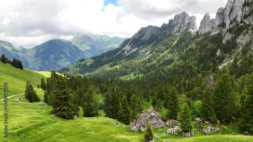 Aerial view, drone flight next to Gastlosen mountain in Switzerland. Gastlosen mountain hike. View  Swiss alps, valley, beautiful hiking spot during cloudy summer day. Straight flight. Amazing nature. photo