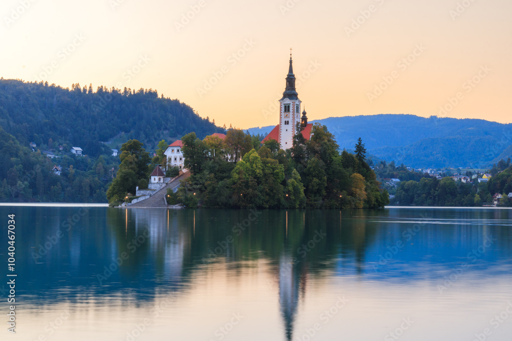 Naklejka premium Lake bled in the slovenian alps slovenia during sunset with warm golden light golden hour