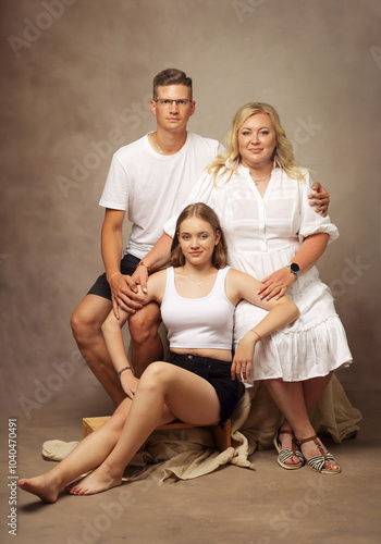 Classic studio family portrait mother father and daughter photo