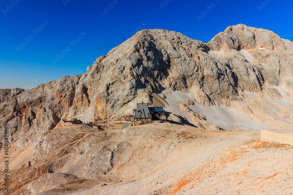 Fototapeta premium Triglav mountain hut with triglav mountain at the morning sun 