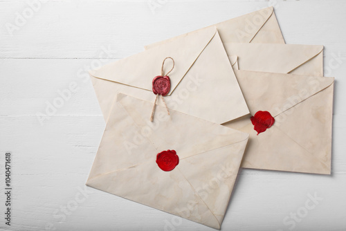 Old letter envelopes on white wooden table, top view photo